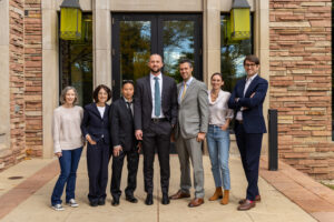 NhRP Senior Communications Director Lauren Choplin, NhRP board member Gail Price-Wise, NhRP Senior Staff Attorney Spencer Lo, NhRP Staff Attorney Jake Davis, NhRP board member Justin Marceau, NhRP Digital Coordinator Kelly Holt, and NhRP Executive Director Christopher Berry stand together in front of the Wolf Law Building on the University of Colorado Boulder campus. 